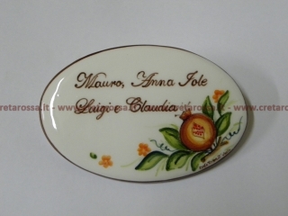 cod.art: nc98 - Mattonella in ceramica ovale 8,5x13 circa con melagrana e scritta personalizzata.